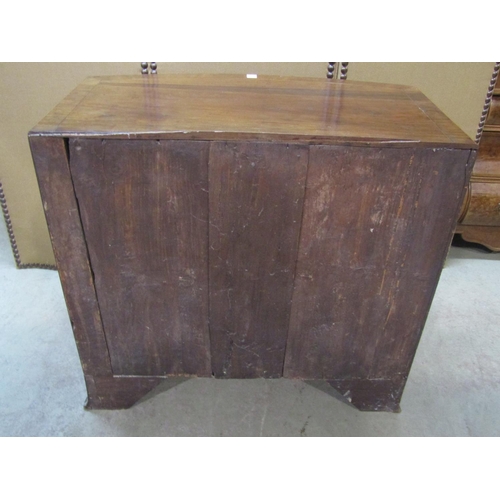 1196 - An early 19th century mahogany caddy top bow fronted bedroom chest of three long graduated drawers w... 