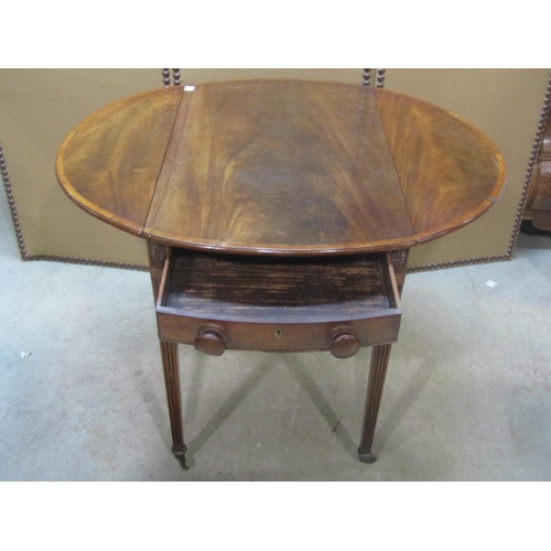 1199 - A Georgian mahogany oval drop leaf Pembroke table with crossbanded detail and usual arrangement of o... 