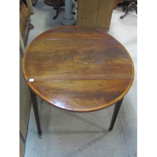 1199 - A Georgian mahogany oval drop leaf Pembroke table with crossbanded detail and usual arrangement of o... 