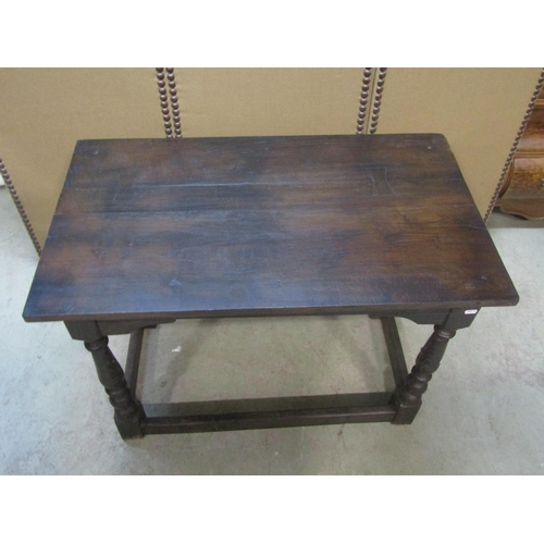 1200 - An antique  oak side/centre table of rectangular form raised on turned and block supports united by ... 