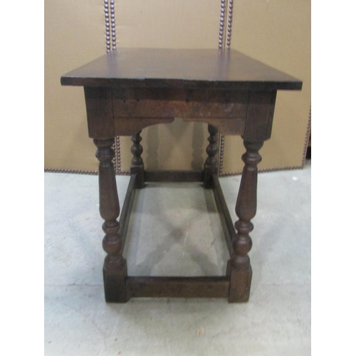 1200 - An antique  oak side/centre table of rectangular form raised on turned and block supports united by ... 