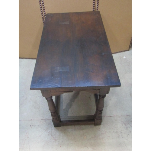 1200 - An antique  oak side/centre table of rectangular form raised on turned and block supports united by ... 