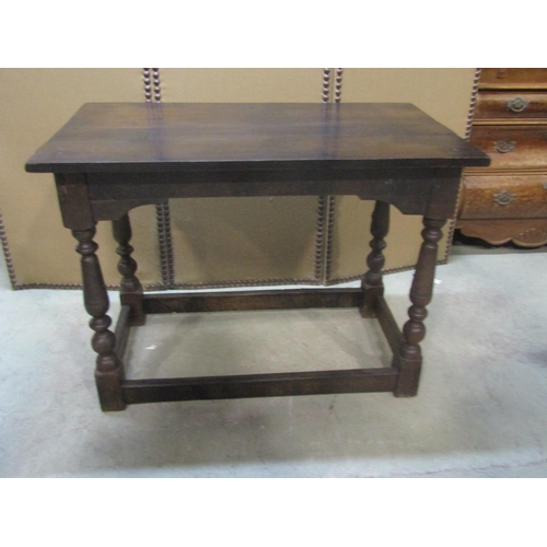 1200 - An antique  oak side/centre table of rectangular form raised on turned and block supports united by ... 