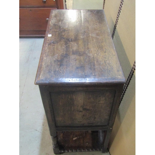 1206 - A good quality old English style oak side cupboard enclosed by a pair of rectangular panelled doors ... 