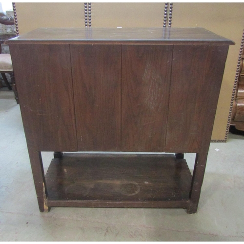 1206 - A good quality old English style oak side cupboard enclosed by a pair of rectangular panelled doors ... 