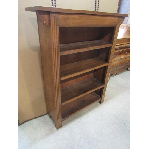 1236 - A small Arts and Crafts style oak freestanding bookcase with three adjustable shelves, flanked by fl... 