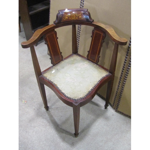 1243 - An Inlaid mahogany corner chair with shaped splats and upholstered pad seat