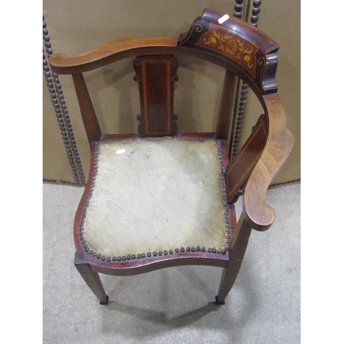 1243 - An Inlaid mahogany corner chair with shaped splats and upholstered pad seat