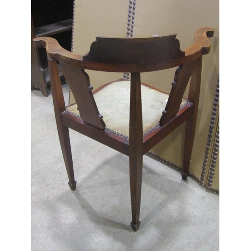 1243 - An Inlaid mahogany corner chair with shaped splats and upholstered pad seat