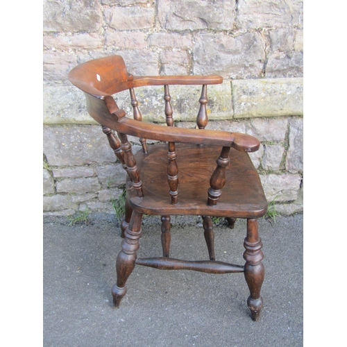 1271 - An antique stained elm and beechwood smokers bow elbow chair with turned spindle back and saddle sha... 