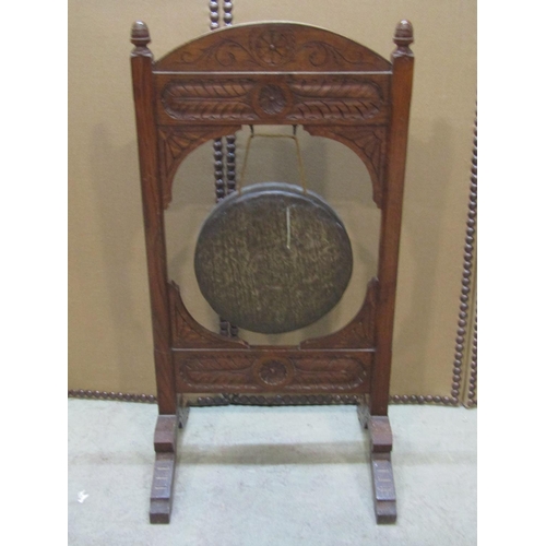 1283 - A late Victorian floorstanding oak framed dinner gong with carved detail 92 cm high x 48 cm wide