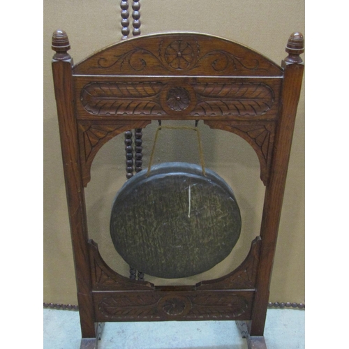 1283 - A late Victorian floorstanding oak framed dinner gong with carved detail 92 cm high x 48 cm wide