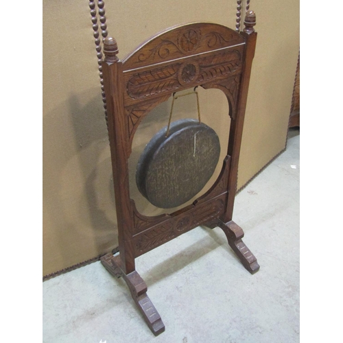 1283 - A late Victorian floorstanding oak framed dinner gong with carved detail 92 cm high x 48 cm wide