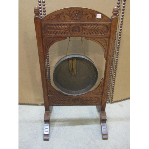 1283 - A late Victorian floorstanding oak framed dinner gong with carved detail 92 cm high x 48 cm wide