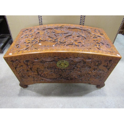 1294 - An Eastern domed top camphor wood coffer/chest with profusely carved detail, 63 cm high x 110 cm lon... 