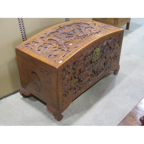 1294 - An Eastern domed top camphor wood coffer/chest with profusely carved detail, 63 cm high x 110 cm lon... 