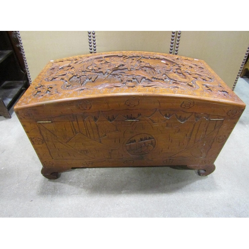 1294 - An Eastern domed top camphor wood coffer/chest with profusely carved detail, 63 cm high x 110 cm lon... 