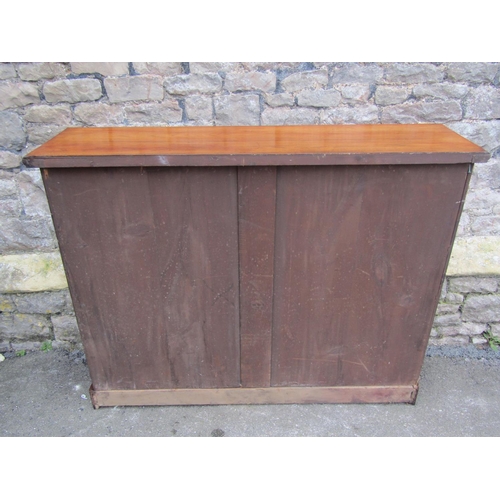 1300 - A late Victorian walnut floorstanding open bookcase with two adjustable shelves and set on a plinth,... 