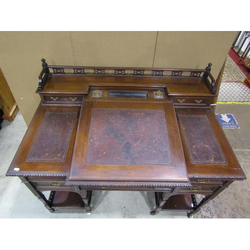 1342 - An Edwardian walnut Dickens type desk fitted with an arrangement of drawers, flanking and surmountin... 