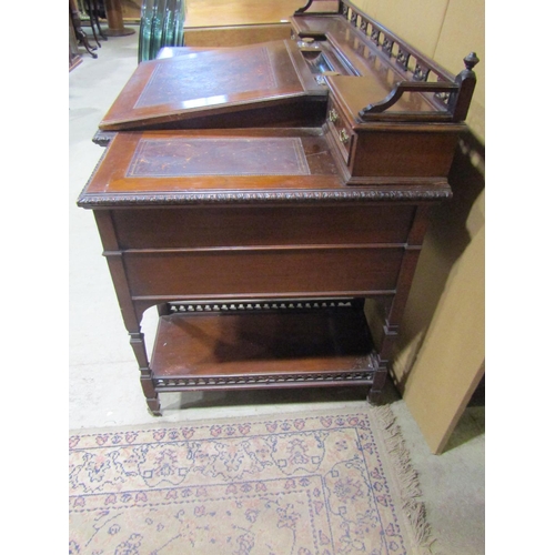 1342 - An Edwardian walnut Dickens type desk fitted with an arrangement of drawers, flanking and surmountin... 