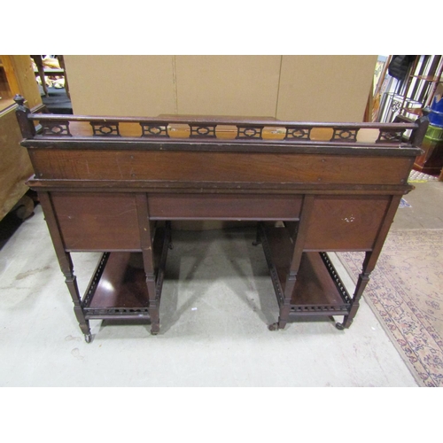 1342 - An Edwardian walnut Dickens type desk fitted with an arrangement of drawers, flanking and surmountin... 