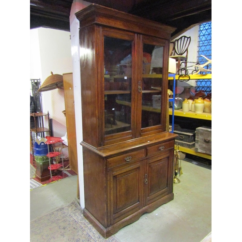 1064 - A late 19th century ashwood library bookcase, the lower section enclosed by two panelled doors and t... 