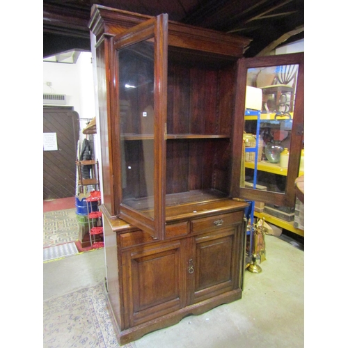 1064 - A late 19th century ashwood library bookcase, the lower section enclosed by two panelled doors and t... 