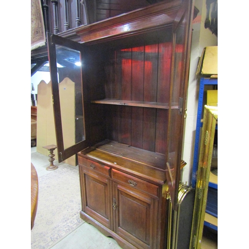 1064 - A late 19th century ashwood library bookcase, the lower section enclosed by two panelled doors and t... 