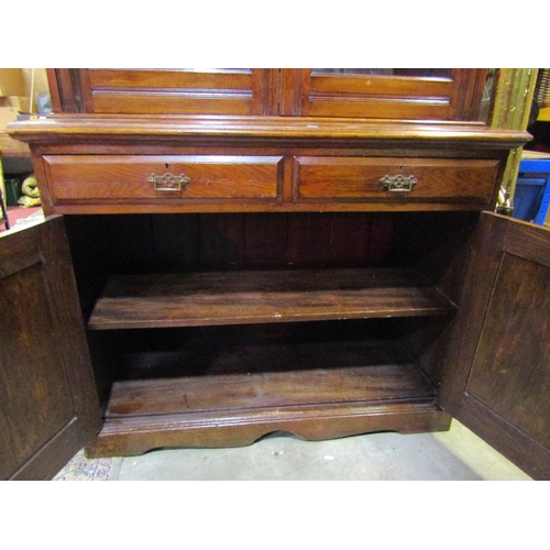 1064 - A late 19th century ashwood library bookcase, the lower section enclosed by two panelled doors and t... 