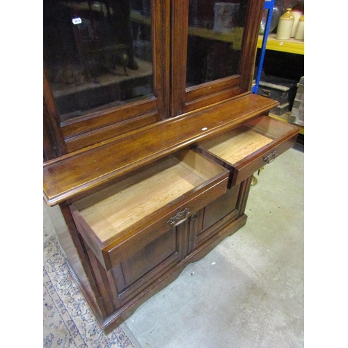 1064 - A late 19th century ashwood library bookcase, the lower section enclosed by two panelled doors and t... 