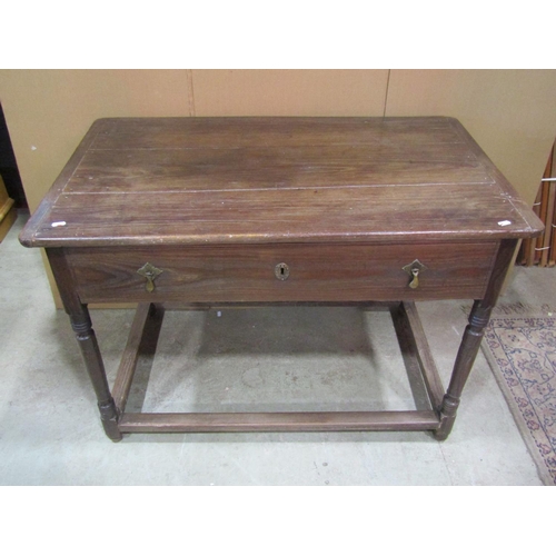 1153 - An antique oak stained pine side table, the plank top with cleated ends over a frieze drawer and tur... 