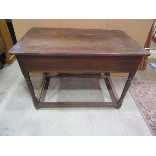 1153 - An antique oak stained pine side table, the plank top with cleated ends over a frieze drawer and tur... 