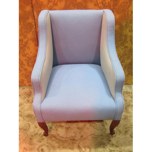 1256 - A 19th century wing armchair with blue and pale grey upholstery raised on carved and scrolled cabrio... 