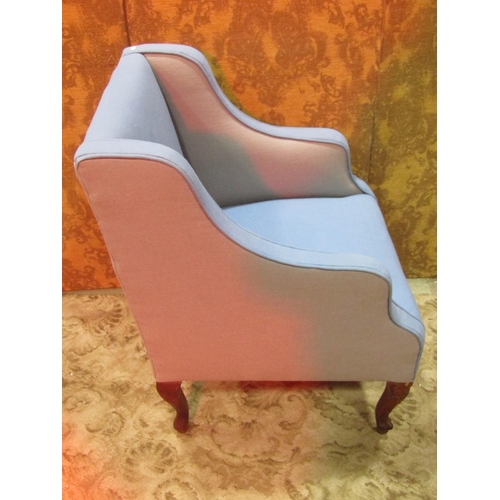 1256 - A 19th century wing armchair with blue and pale grey upholstery raised on carved and scrolled cabrio... 