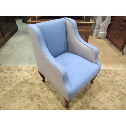 1256 - A 19th century wing armchair with blue and pale grey upholstery raised on carved and scrolled cabrio... 