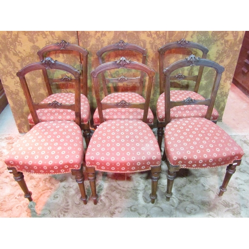 1269 - A set of six Victorian walnut dining chairs with carved and moulded frames, upholstered seats and tu... 