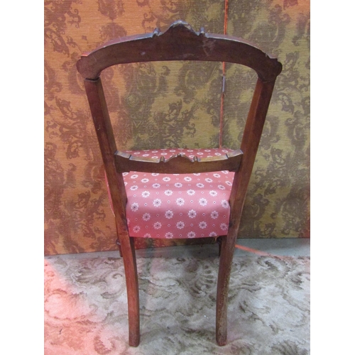 1269 - A set of six Victorian walnut dining chairs with carved and moulded frames, upholstered seats and tu... 