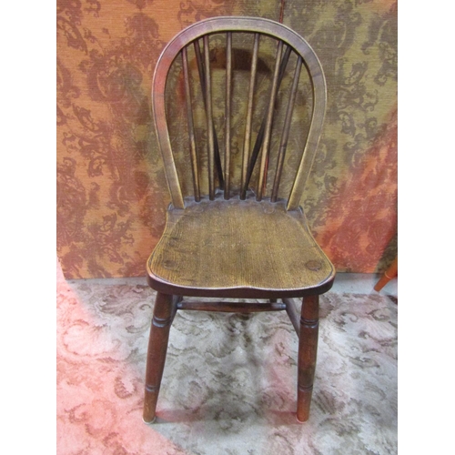 1111 - A set of eight Windsor elm and beechwood hoop and stick back dining chairs with saddle shaped seats ... 