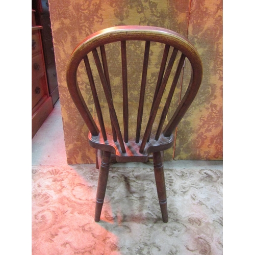 1111 - A set of eight Windsor elm and beechwood hoop and stick back dining chairs with saddle shaped seats ... 