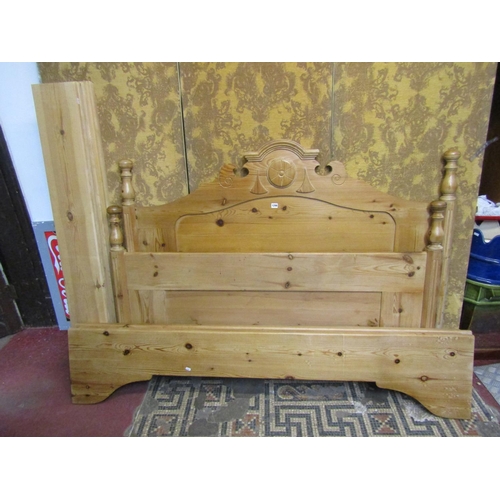 1296 - A stripped pine double bedstead with turned finials and arched and moulded headboard (complete with ... 