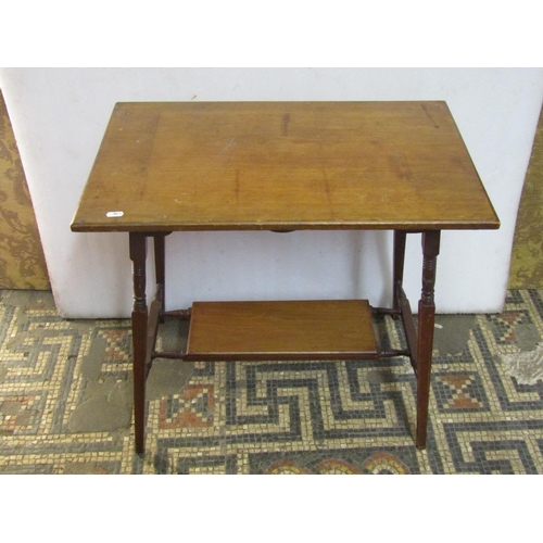 1304 - An Edwardian Arts & Crafts style walnut two tier  occasional table of rectangular form raised on tur... 