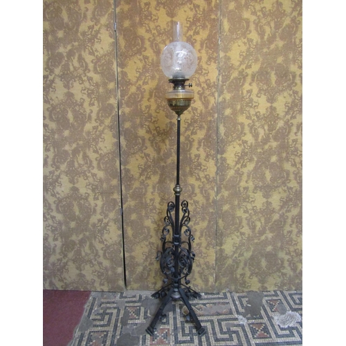 1310 - A late Victorian telescopic oil lamp standard with good quality scrolled wrought iron base beneath a... 