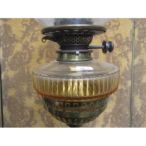 1310 - A late Victorian telescopic oil lamp standard with good quality scrolled wrought iron base beneath a... 