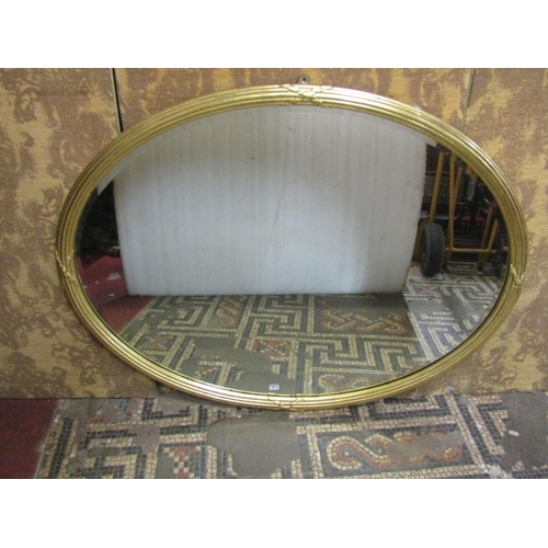 1319 - A 19th century gilded wall mirror with reeded and ribbon garland frame with original bevelled edge m... 