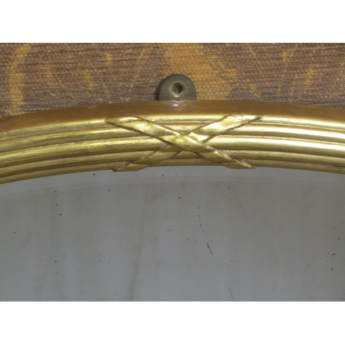 1319 - A 19th century gilded wall mirror with reeded and ribbon garland frame with original bevelled edge m... 