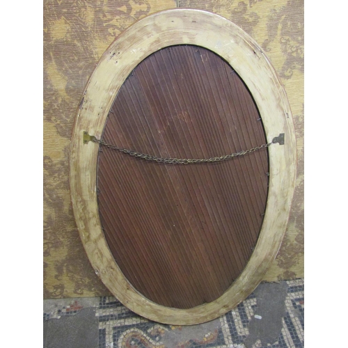 1330 - An Oval gilt framed wall mirror with bevelled edge plate, ball surround, with reeded and cross hatch... 