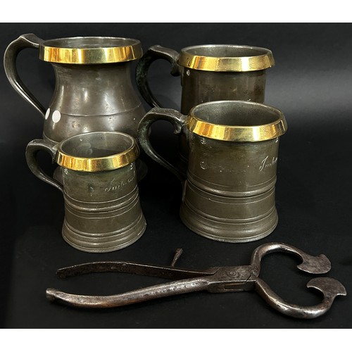 226 - A collection of seven early 19th century pewter tankards some with brass rims, a pewter funnel, larg... 