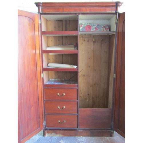 1351 - A substantial Victorian mahogany wardrobe with turret corners enclosed by a pair of arched and panel... 