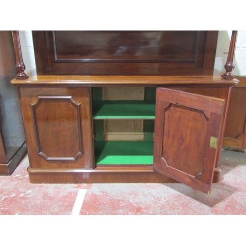 1357 - A Victorian mahogany buffet, the lower section enclosed by three panelled doors, turned columns and ... 