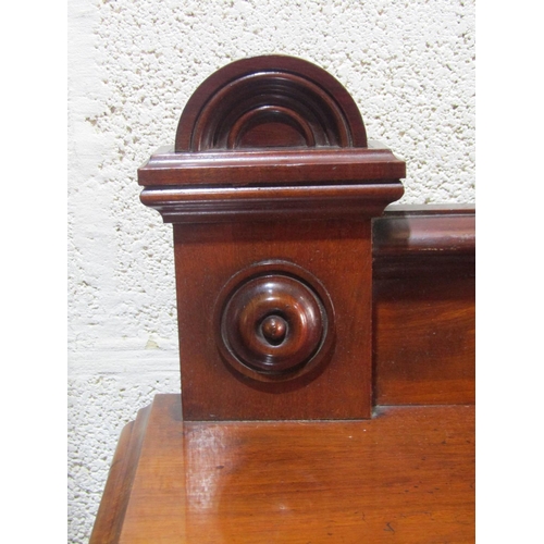 1357 - A Victorian mahogany buffet, the lower section enclosed by three panelled doors, turned columns and ... 